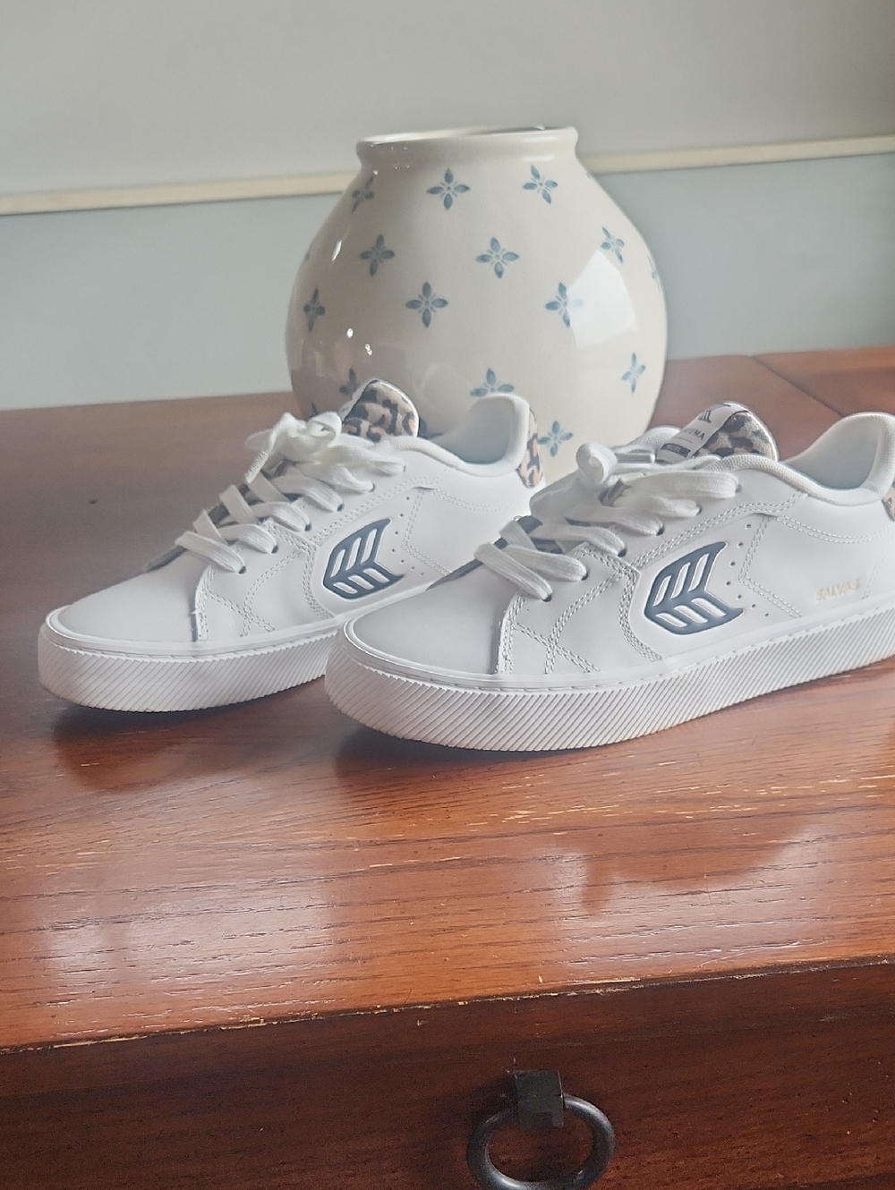Cariuma White Sneakers with Navy Logo and Leopard Heel Accent